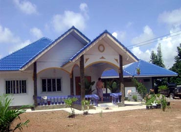 Roofer Working On Exterior Of New Home